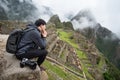 Asian man tourist looking at Machu Picchu