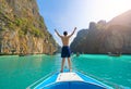 An Asian man, a tourist, standing on a boat to snorkeling or diving in Krabi with blue turquoise seawater, Phuket island in summer Royalty Free Stock Photo