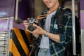 An Asian man traveler backpacker is taking pictures with his camera while getting off the train Royalty Free Stock Photo