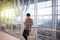 Asian man traveler using mobile phone in airport,Lifestyle using cell phone connection concept Royalty Free Stock Photo