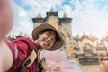 Asian man traveler wearing a hat smile selfie with architecture pagoda ancient of Asia Royalty Free Stock Photo