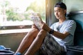 Asian man traveling backpacker reading map sit on the old train seat Royalty Free Stock Photo