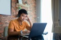 Asian man uses a notebook computer and works hard and meeting at home and he is stressed and Headache Royalty Free Stock Photo