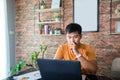 Asian man uses a notebook computer and works hard and meeting at home and he is stressed and Headache Royalty Free Stock Photo