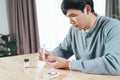 Asian man using lancet on finger for checking blood sugar level by Glucose meter, Healthcare and Medical, diabetes, glycemia Royalty Free Stock Photo