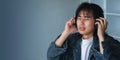 Asian man using laptop at home and listening music on a headphones Royalty Free Stock Photo