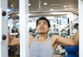 Asian man using lat pulldown machine Royalty Free Stock Photo