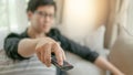 Asian man using remote controller while watching TV Royalty Free Stock Photo