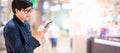 Asian man using smartphone in shopping mall Royalty Free Stock Photo