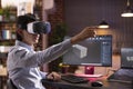 Asian man using vr headset and working remotely on 3d container model Royalty Free Stock Photo