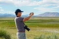 Asian man visiting and taking photo of the nice landscape