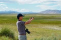 Asian man visiting and taking photo of the nice landscape