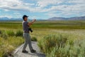 Asian man visiting and taking photo of the nice landscape