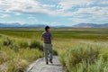 Asian man visiting and taking photo of the nice landscape