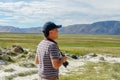 Asian man visiting and taking photo of the nice landscape