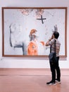 An asian man visits an exhibition at the indonesian national gallery museum