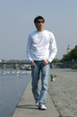 Asian Man Walking along the Embankment Royalty Free Stock Photo