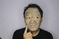 Asian Man was thinking and day dreaming when he use beauty face mask Royalty Free Stock Photo