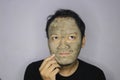 Asian Man was thinking and day dreaming when he use beauty face mask Royalty Free Stock Photo