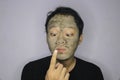 Asian Man was thinking and day dreaming when he use beauty face mask Royalty Free Stock Photo