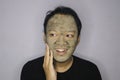 Asian Man was thinking and day dreaming when he use beauty face mask Royalty Free Stock Photo