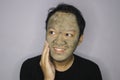 Asian Man was thinking and day dreaming when he use beauty face mask Royalty Free Stock Photo