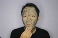 Asian Man was thinking and day dreaming when he use beauty face mask Royalty Free Stock Photo