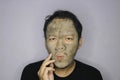 Asian Man was thinking and day dreaming when he use beauty face mask Royalty Free Stock Photo