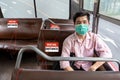 Asian man wear protective mask make social distancing for shuttle bus during CoVID-19. New normal behavior lifestyle in daily