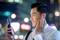 Asian man wear wireless earbuds Royalty Free Stock Photo