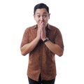 Asian Man Wearing Batik Shirt Shocked and Closing his Mouth