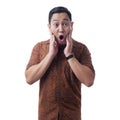 Asian Man Wearing Batik Shirt Shocked With Open Mouth Royalty Free Stock Photo