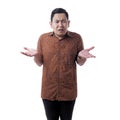 Asian man wearing batik shirt shows indifferent gesture Royalty Free Stock Photo