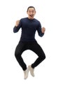Asian man wearing blue shirt black denim and white shoes, jump while screaming shouting celebrating victory, winning gesture Royalty Free Stock Photo