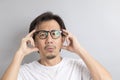 Asian man wearing eyeglasses with surprise and wonder expression Royalty Free Stock Photo