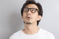 Asian man wearing eyeglasses with surprise and wonder expression Royalty Free Stock Photo