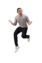 Asian man wearing grey shirt black denim and white shoes, jump while screaming shouting celebrating victory, winning gesture Royalty Free Stock Photo