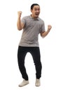 Asian man wearing grey shirt black denim and white shoes, screaming shouting celebrating victory, winning gesture. Full body Royalty Free Stock Photo