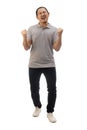 Asian man wearing grey shirt black denim and white shoes, screaming shouting celebrating victory, winning gesture. Full body Royalty Free Stock Photo