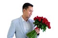 Asian man wearing grey suit holding a bouquet of red roses Royalty Free Stock Photo