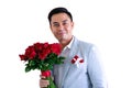 Asian man wearing grey suit holding a bouquet of red roses and red gift box Royalty Free Stock Photo