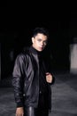 an Asian man wearing a leather jacket and black pants with a handsome face Royalty Free Stock Photo