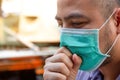 Asian man wearing protective face masks coughing. Sick man with flu wearing mask and blowing nose, epidemic flu concept. Royalty Free Stock Photo