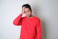 Asian man wearing red clothes looking stressed expression