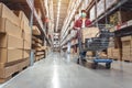 Asian man wearing a shopping mask in Rows of shelves with goods boxes in modern industry warehouse store at factory warehouse Royalty Free Stock Photo