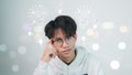 Asian man wears glasses who is thinking looking up with a simple thought headlight above a gray background.original concept.Idea Royalty Free Stock Photo