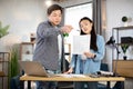 Asian man and woman analysing financial report or project plan at office Royalty Free Stock Photo