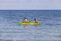 Asian man and woman with his dog in a kayak swims on the sea near island Koh Samet, Thailand Royalty Free Stock Photo