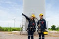 Asian man and woman Inspection engineers preparing and progress check of a wind turbine with safety in wind farm in Thailand Royalty Free Stock Photo