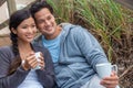 Asian Man Woman Romantic Couple on Beach Steps Drinking Coffee or Tea Royalty Free Stock Photo